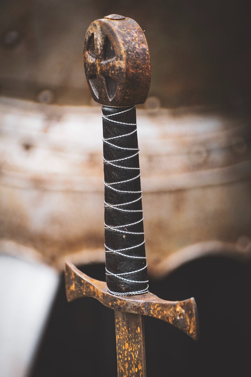 https://www.pexels.com/photo/closeup-photo-of-black-hilt-and-brown-sword-1383766/