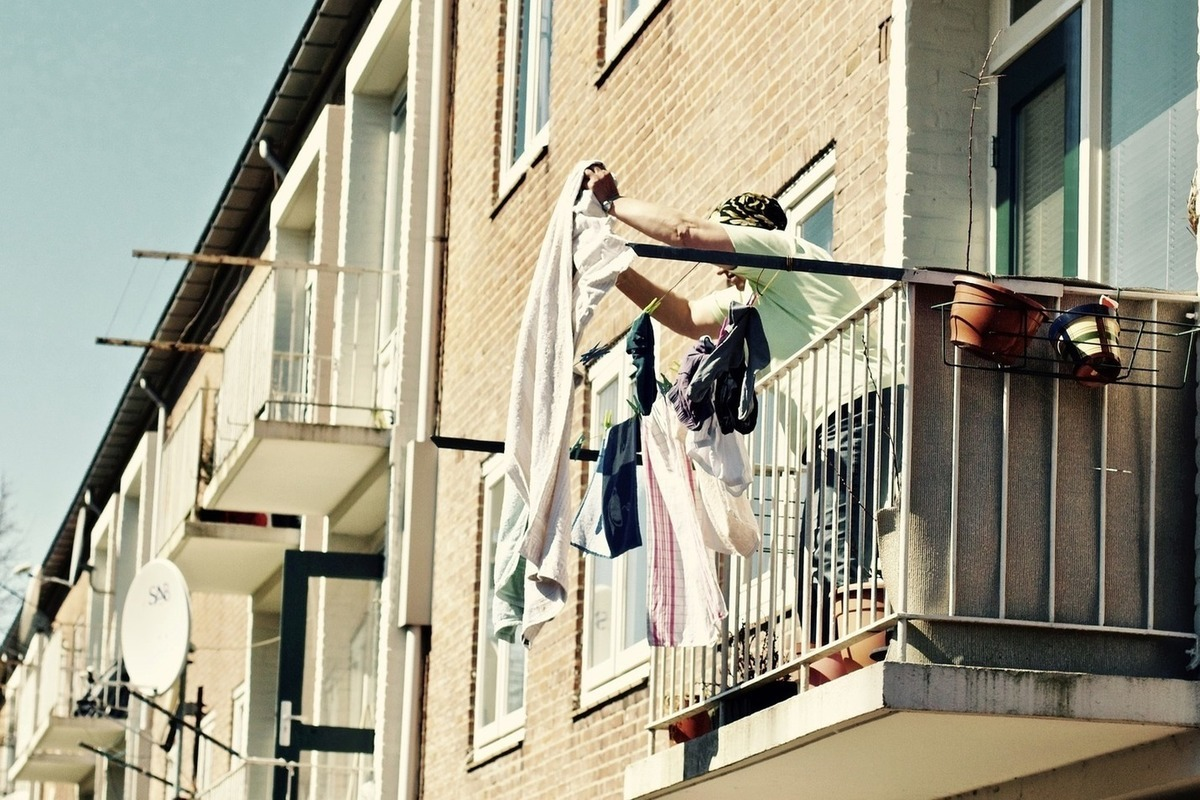 Кидали одежда. Человек на балконе. Фотосессия на балконе. Женщина на балконе. Вытряхивать с балкона.