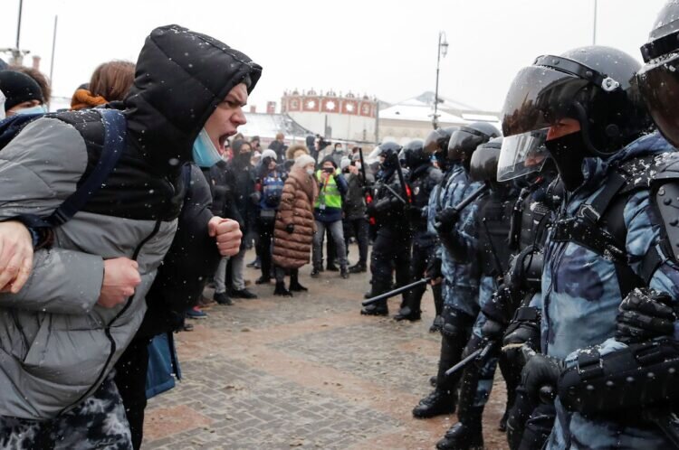A man shouts in front of law enforcement officers during a rally in support of jailed Russian opposition. Russia January 31, 2021. REUTERS/Maxim Shemetov