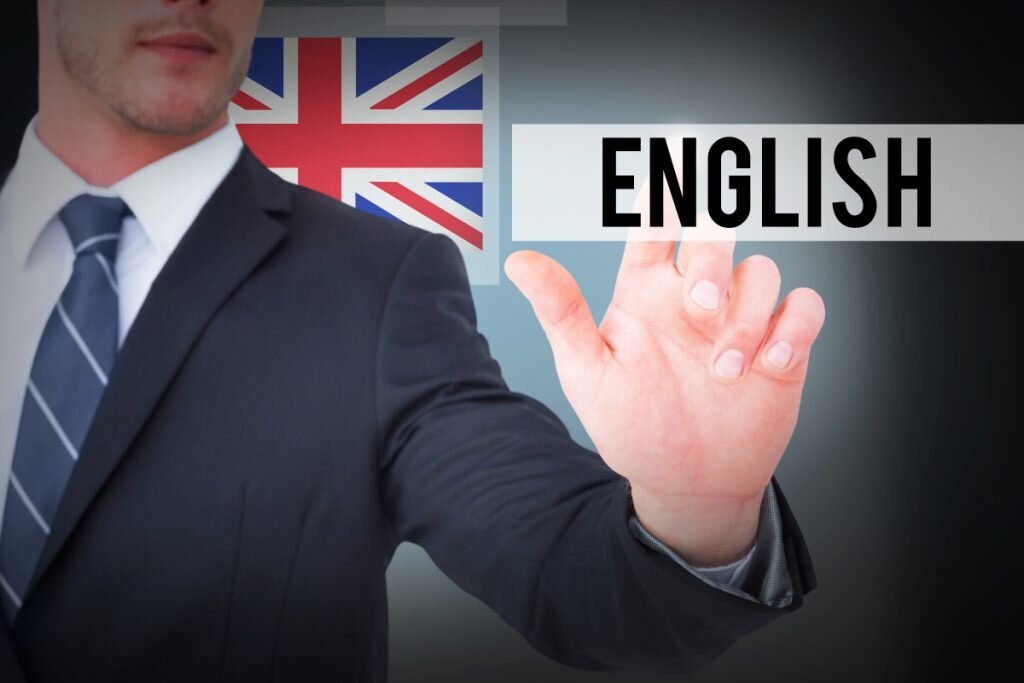 The word english and focused businessman pointing with his finger against blue background with vignette