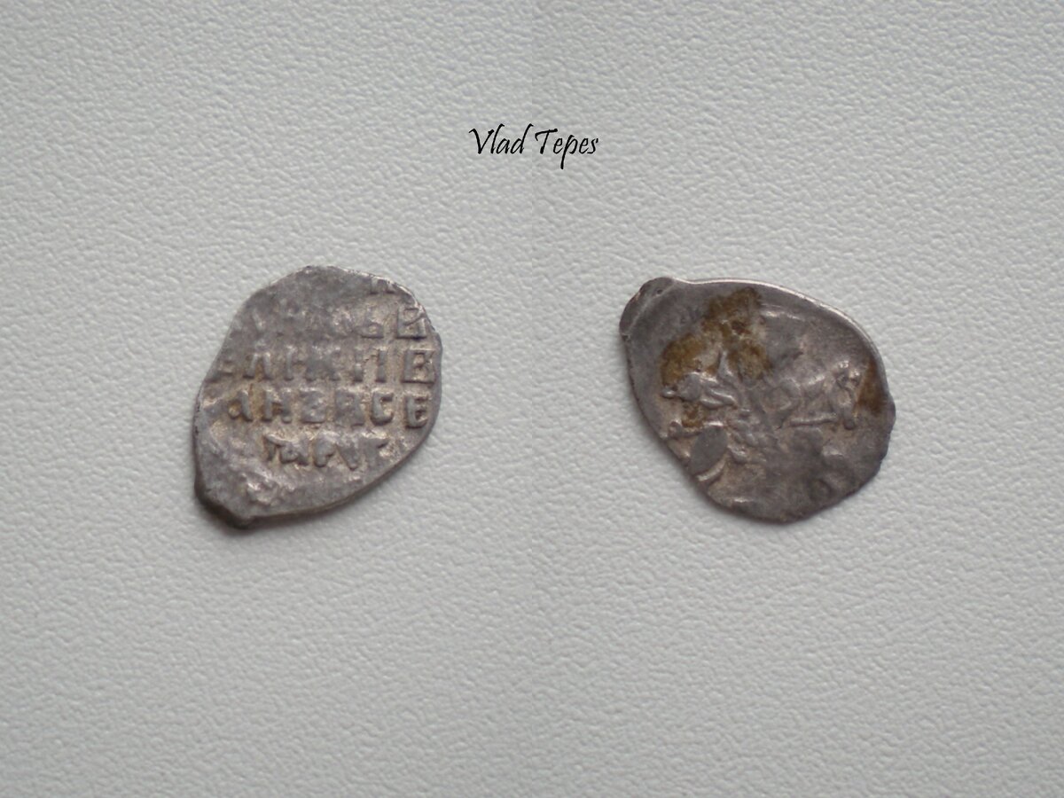 Фотография серебряной копейки эпохи Ивана Грозного, отчеканенной в Новгороде после 1547 г. Легенда в 5 строк: "ЦРЬИ/КNSЬВ/ЕЛIКIIВ/АNЪВСЕ/ЯРУСI". Десять таких копеек составляли в то время гривну, а сотня - рубль