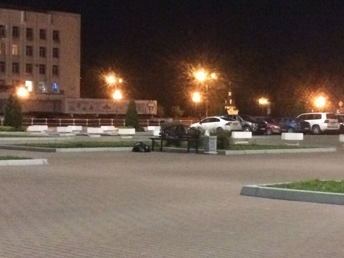 Человек лежит возле скамейки