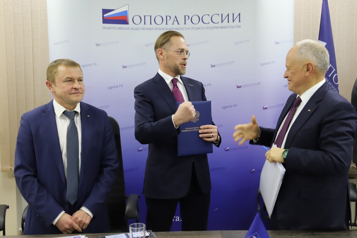 Президент "Опоры" Александр Калинин и председатель попечительского совета "Опоры" Сергей Борисов вручают Игорю Черноголову благодарственное письмо президента России