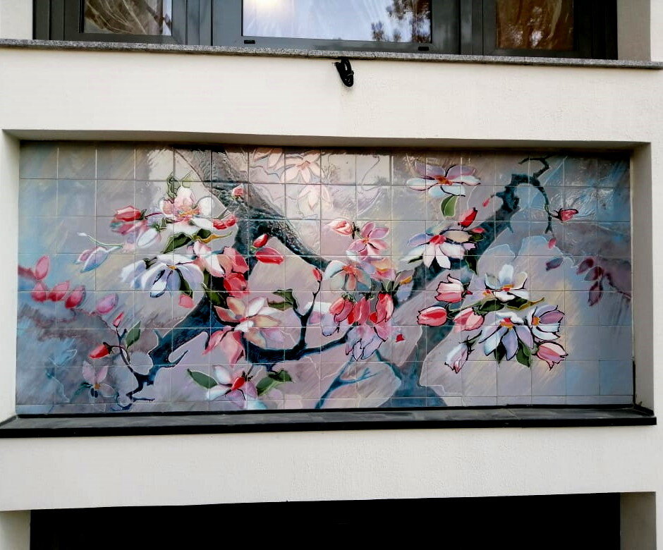 Дом облицован нашими панно с нежными акварельными композициями, выполненными в технике многослойной живописи глазурями.