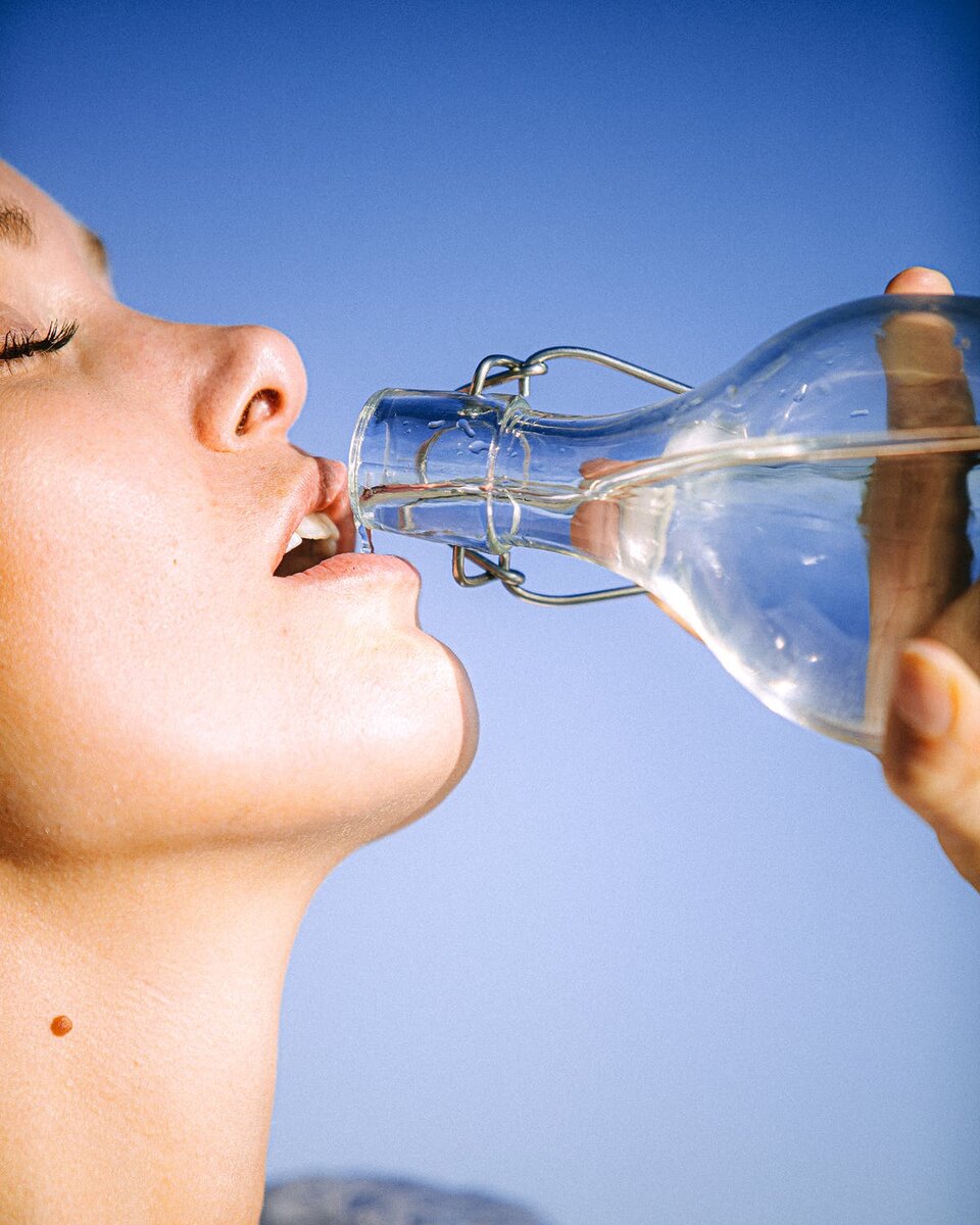 https://www.pexels.com/photo/woman-drinking-water-from-glass-bottle-3124674/