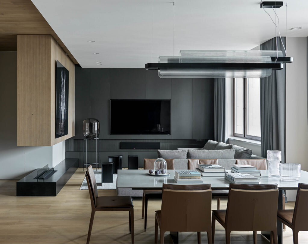 Вид из кухни на общую зону. Подвесной шкаф над камином и шкаф за телевизором — столярная мастерская “Квинтон”. Основание биокамина из гранита. Над камином работа Влада Локтева из серии Balance & Freedom.