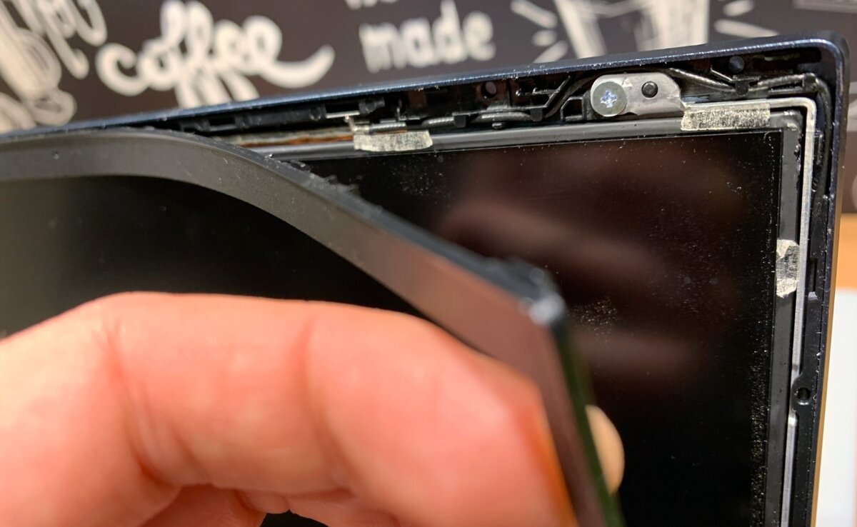 Процесс снятия декоративной рамки вокруг матрицы ноутбука