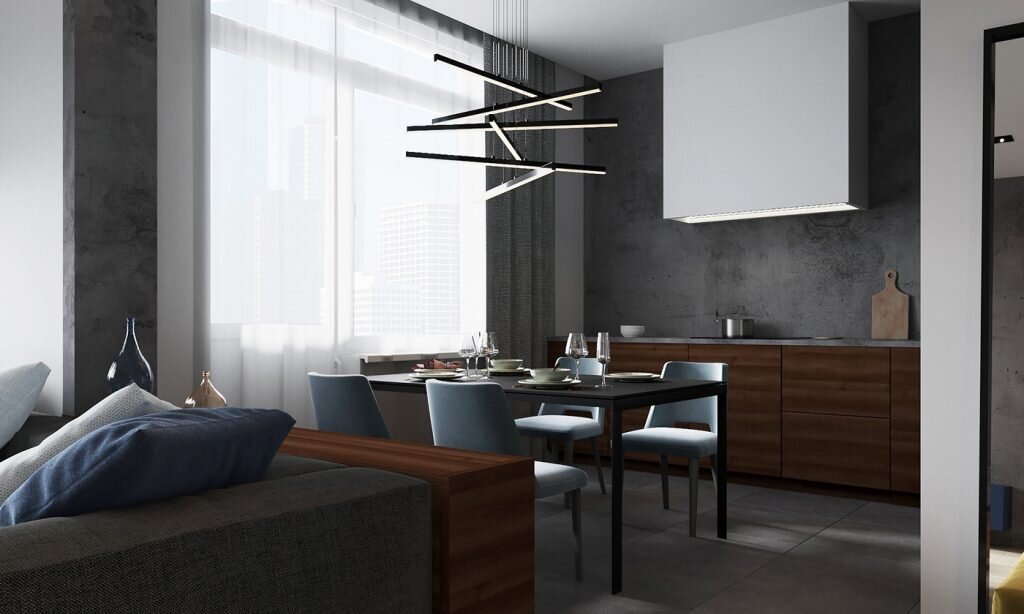 Интерьер очень лаконичный, понятный, но, в то же время, интересный и фактурный. Основа — бетон, на фоне которого ярким контрастом играет древесина теплого насыщенного оттенка и синий бархат мебели. 