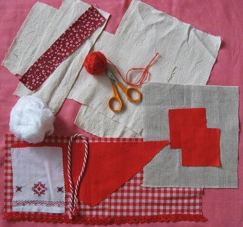 В середину лоскута кладем наполнитель(вату или синтепон), формируем голову. Из красных квадратов делаем небольшую грудь.