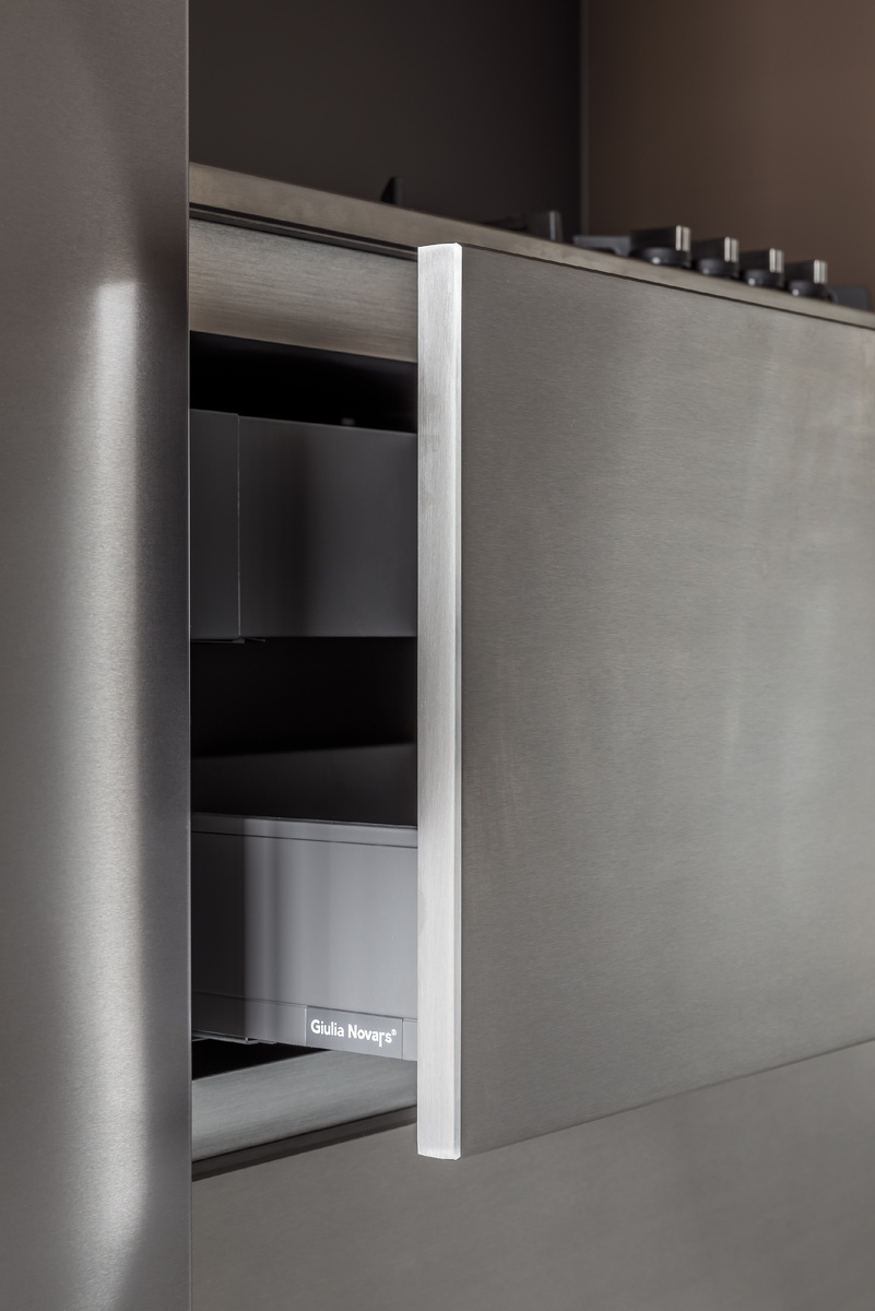 Фасады, рабочие поверхности, декоративные панели Giulia Novars выполняются в отделке нержавеющей сталью с элегантными фасками по всему периметру каждого изделия. Технология создания таких фасадов отличается высокой трудоемкостью, требует скрупулезной точности и включает в себя множество этапов обработки, значительная часть которых выполняется вручную.