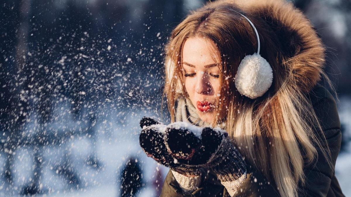    Девушка сдувает снег с варежек:Unsplash/freestocks