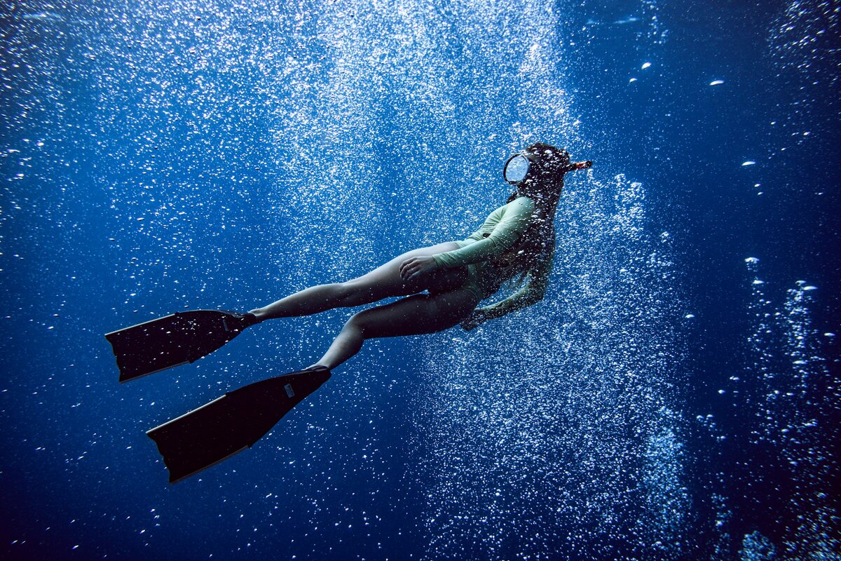 Man Underwater. Фридайвинг. The Reef: Stalked. Man and woman Underwater.