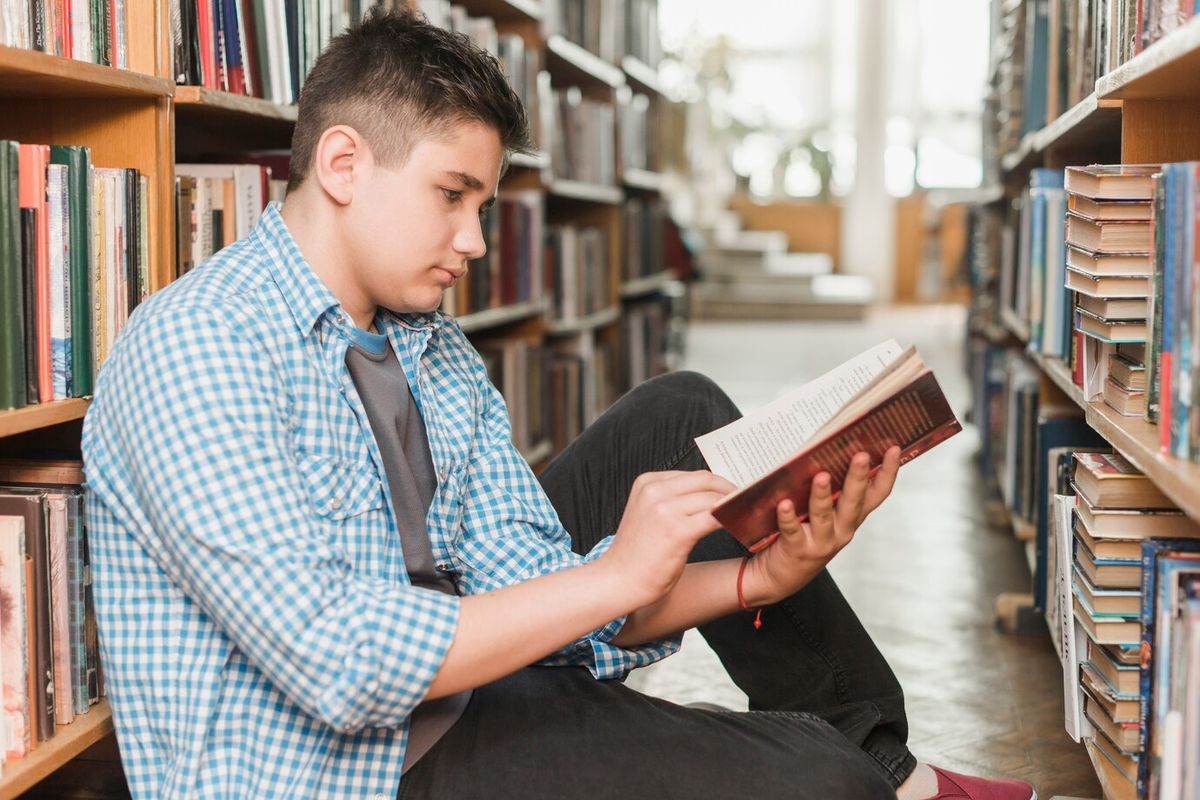 Подросток читает книгу. Подросток с книгой. Подростки за чтением. Молодежь и чтение. Подросток с книжкой.