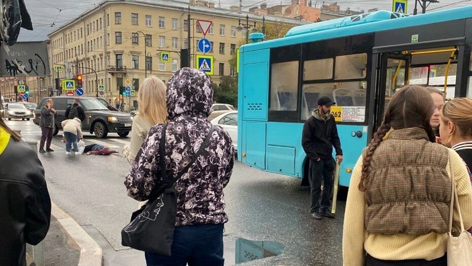    Прохожие пытаются помочь школьнице, которую сбил автобус на Василеьевском острове. Автор фото: t.me/Megapolisonline