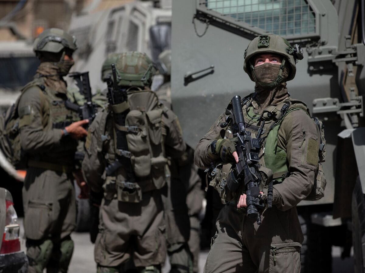    Израильские военнослужащие во время операции по поиску палестинских боевиков в деревне Акраба недалеко от города Наблус© AP Photo / Majdi Mohammed