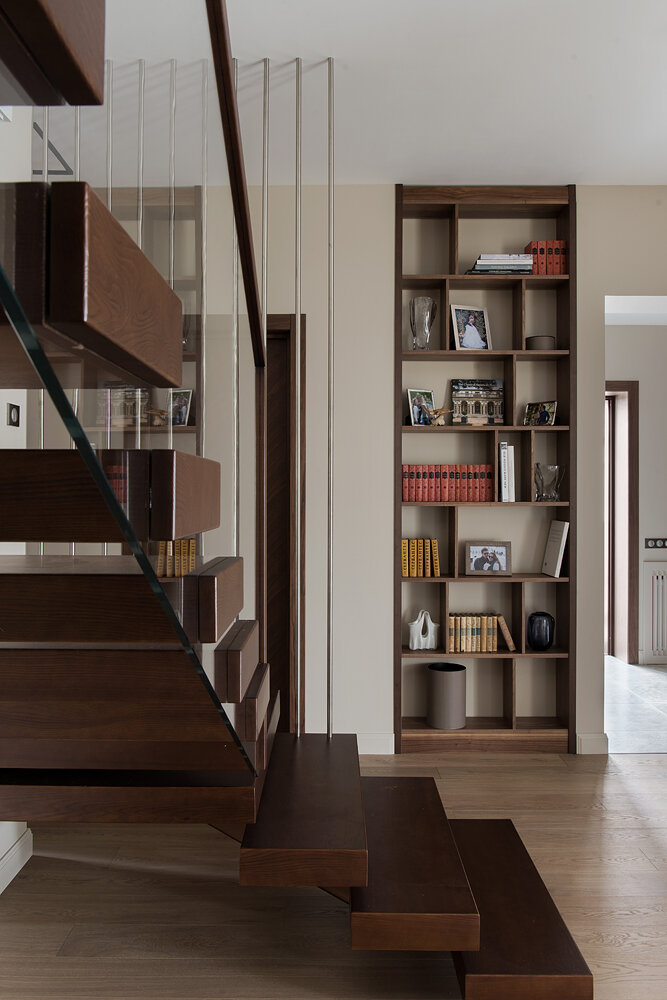 Двухэтажный загородный дома. Консольные ступени лестницы со стеклянным ограждением