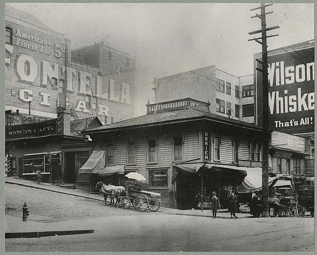 Transcribed from photograph: "Seattle Streets. Cherry St. Ca. 1900. Looking southeast from 2nd Ave. Manca's Café in background." Общественное достояние