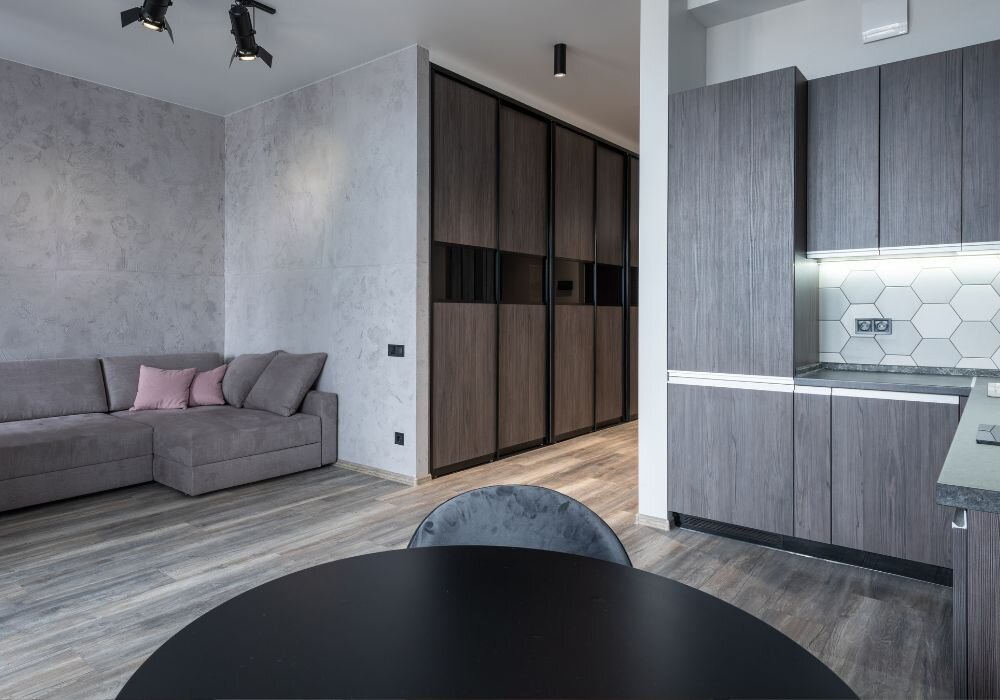 Квадратная кухня-гостиная с угловой кухней и обеденным столом