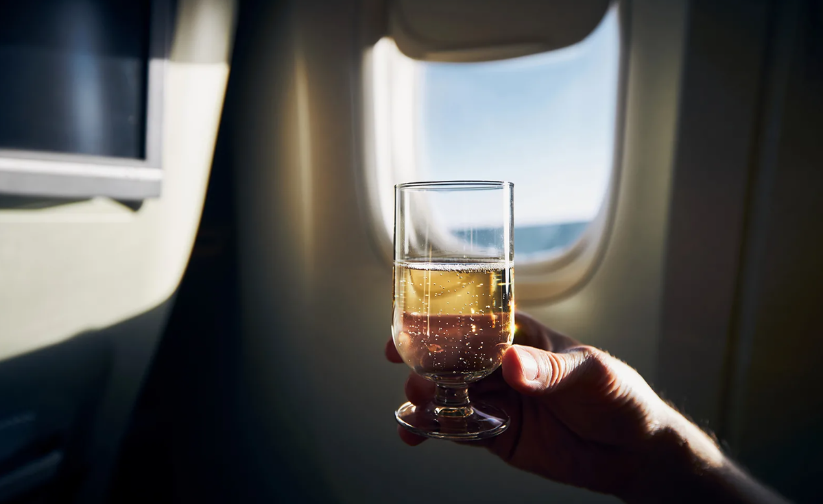 Шампанское в самолете можно. Шампанское в самолете. Вино на борту самолета. Бокал шампанского в самолете. Шампанское на борту самолета.