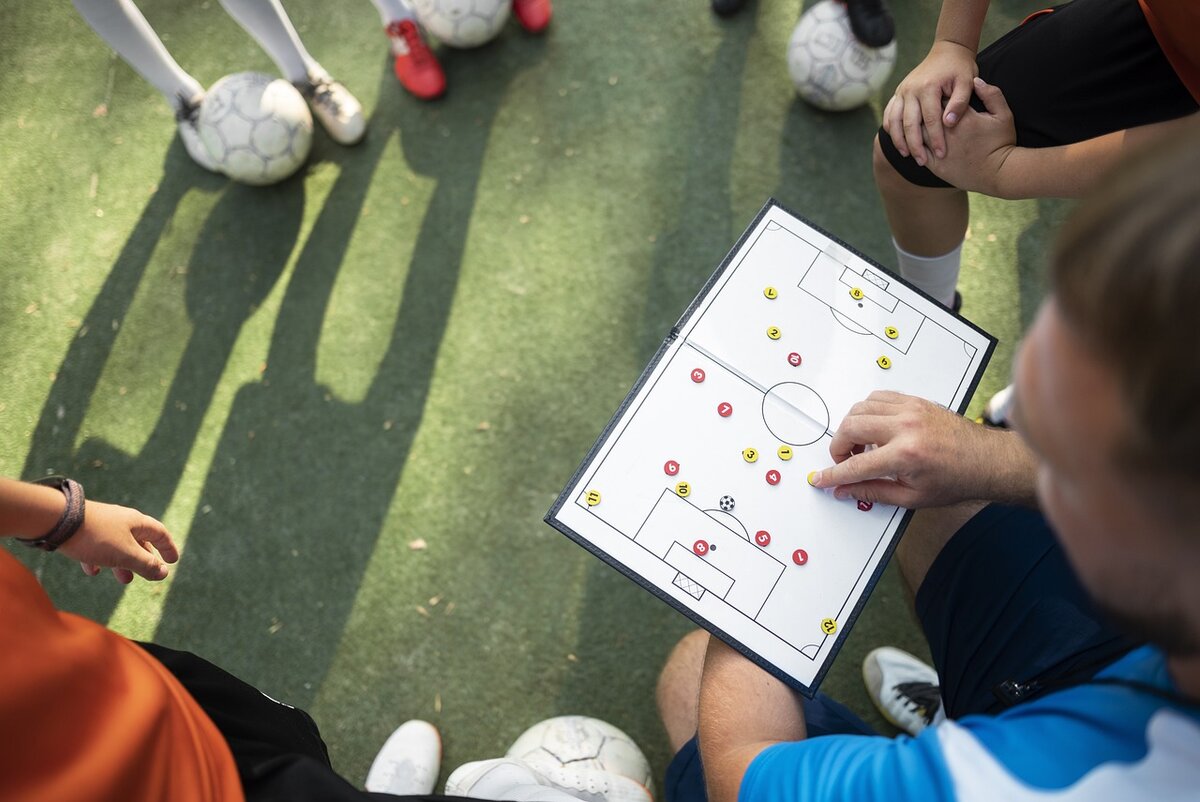 Football Trainer hand in a Pocket