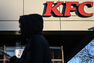    Мужчина у вывески сети ресторанов KFC в Москве ©Павел Бедняков РИА Новости