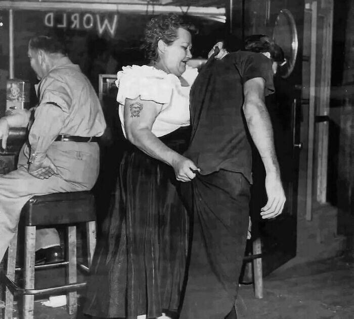 Бойкая женщина-вышибала выкидывает из американского бара дебошира, 1953 год.