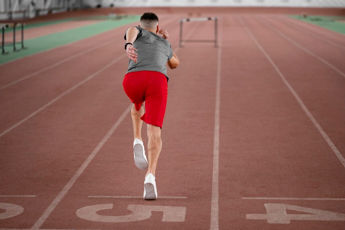 Беги более быстрее. Спортсмен крупный план. Рыжий спортсмен в полный рост. Full shot