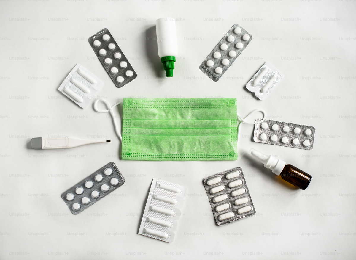 https://unsplash.com/photos/a-group-of-pills-a-face-mask-and-other-medical-supplies-HYobs3xpBr4