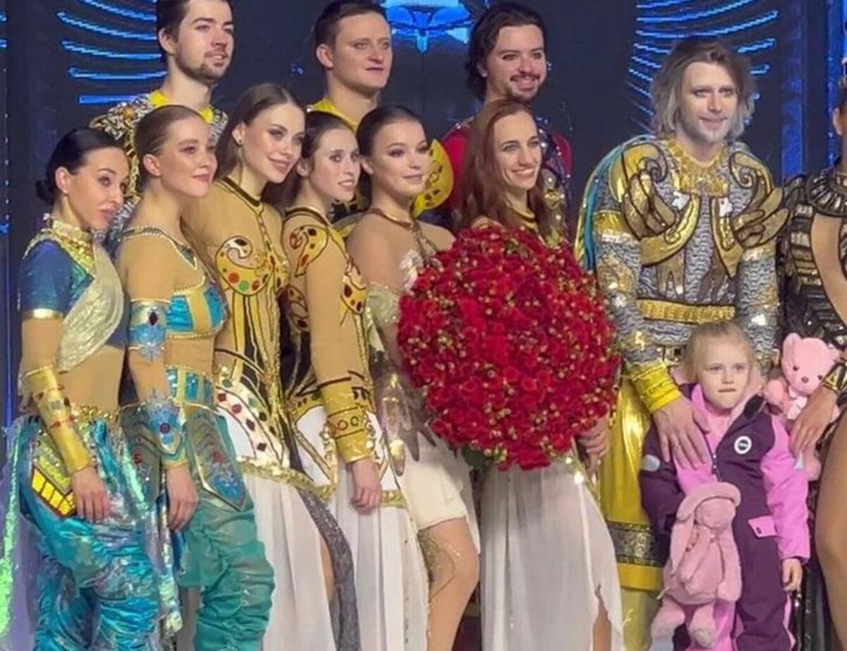    В кадре Петр держит Милу за плечи и позирует с ней для фото в окружении других участников шоу