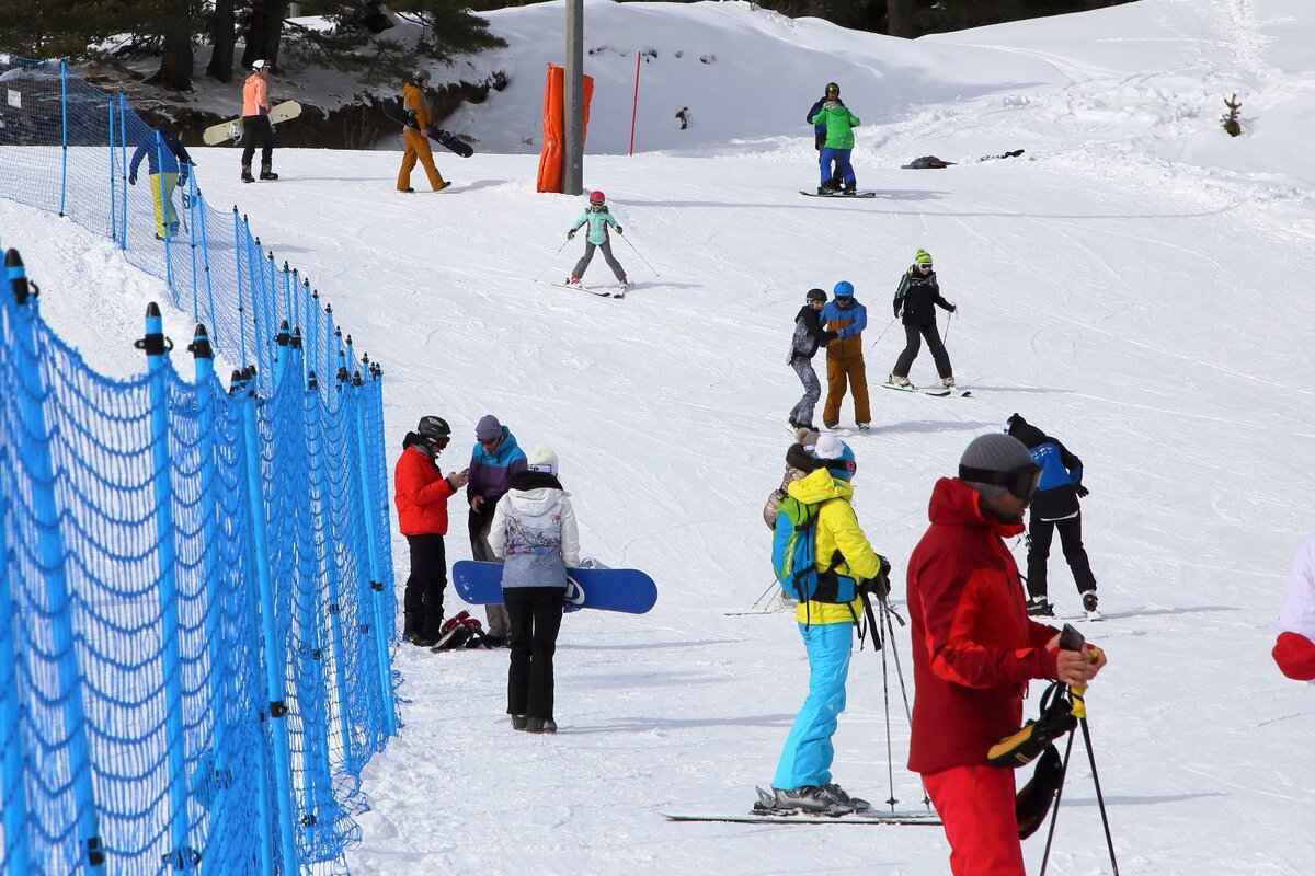 На переднем плане в желтой куртке и голубых штанах — наша ребёночка. На заднем плане в бирюзовой куртке и серых штанах, лыжи плугом  — ее ребёночка.