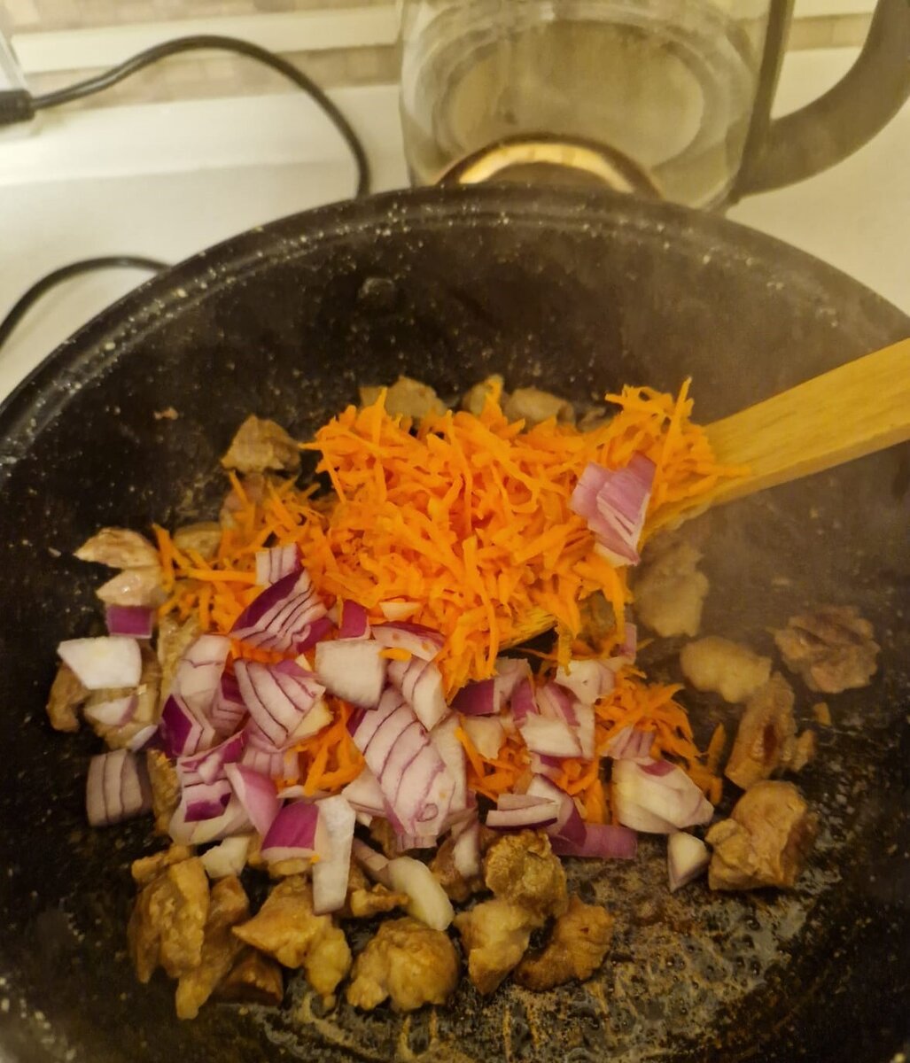 Добавляем к обжаренному мясу лук, натёртую морковь и сладкий перец (я добавила сушенный).