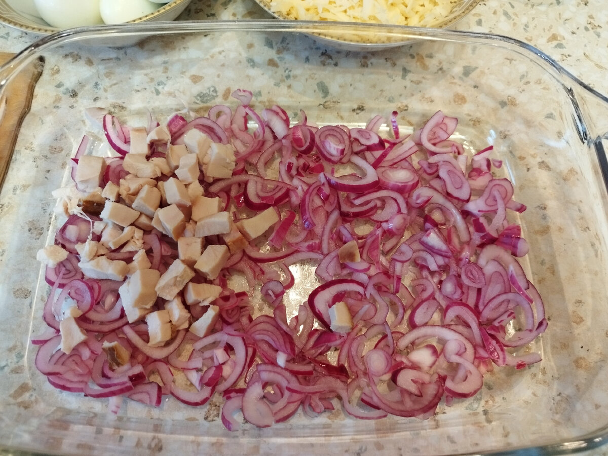 На отжатый маринованный лук кладём отварную куриную грудку.