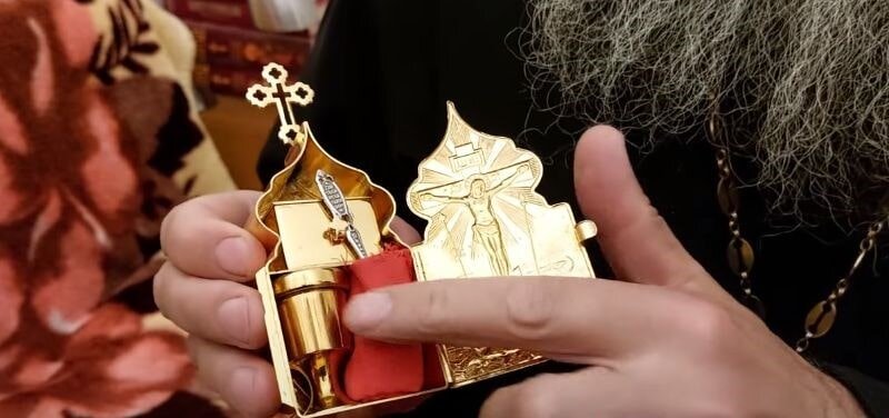 Отец Андрей показывает свою Чашу с плотной крышкой.