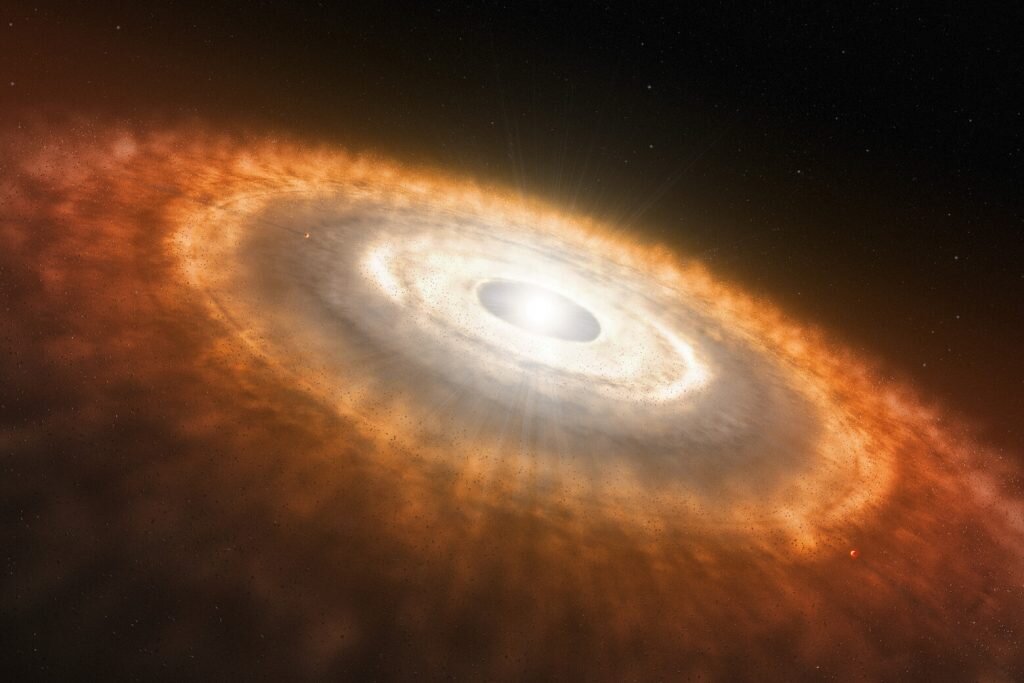    This is an artist’s impression of a young star surrounded by a protoplanetary disc in which planets are forming. An international team of astronomers have used the NASA/ESA/CSA James Webb Space Telescope to provide the first observation of water and other molecules in the inner, rocky-planet-forming regions of a disc in one of the most extreme environments in our galaxy. These results suggest that the conditions for rocky-planet  formation, typically found in the discs of low-mass star-forming regions, can also occur in massive-star-forming regions and possibly a broader range of environments. [Image description: At the centre of the image, a bright light source illuminates a surrounding disc, which transitions from colours of white, grey, to orange. The disc is slightly tilted from upper left to lower right, and has spiral features that are most prominent near the star. Small, rocky objects are scattered throughout the disc. At upper right, there is a gap through which background stars can be seen.] Александр Шереметьев