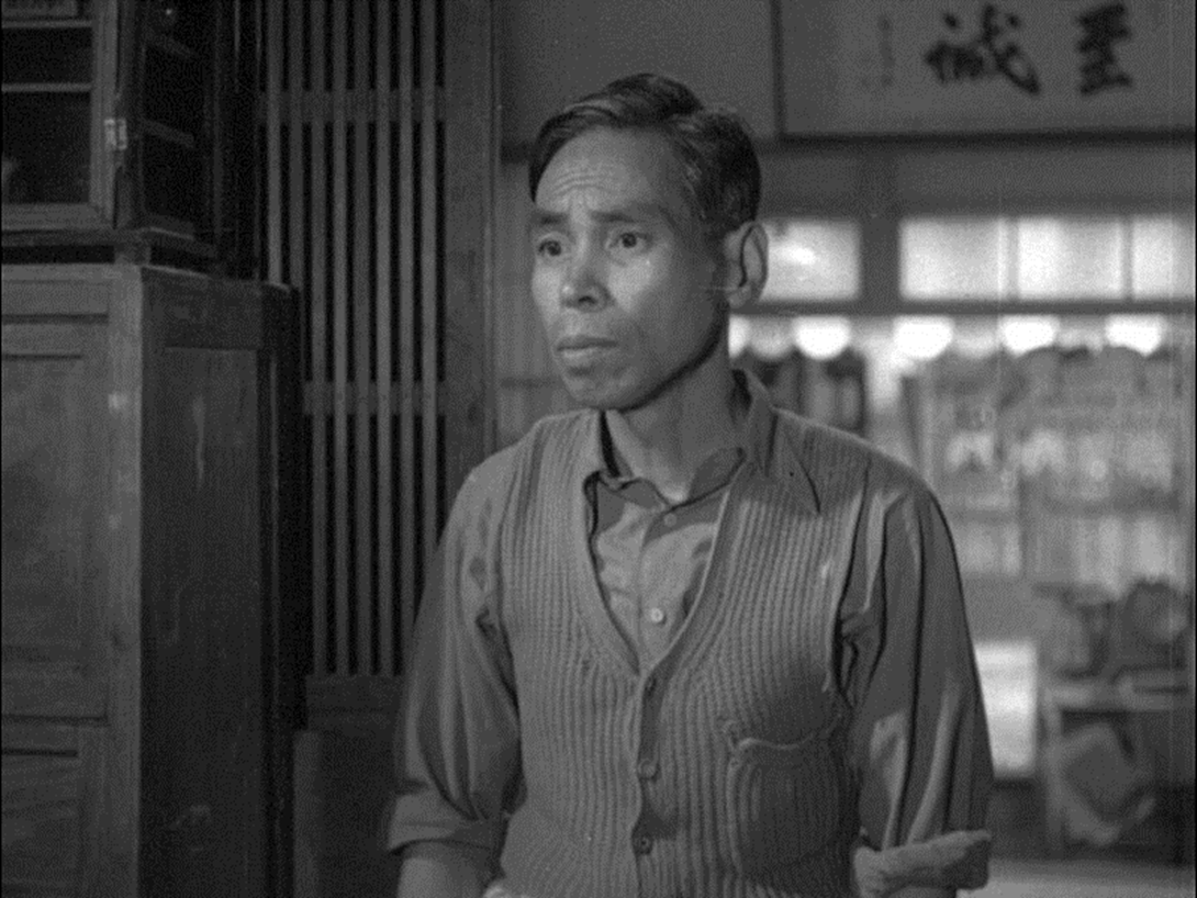 Дзеко Накамура в фильме «Окасан» (Okaasan, おかあさん) режиссера Микио Нарусэ (Mikio Naruse), 1952 год.  
Источник: https://commons.wikimedia.org/wiki/File:Zek%C5%8D_Nakamura_in_Okaasan,_1952.jpg
