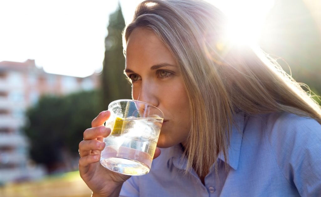    Portrait of beautiful young woman drinking soda in a restaurant terrace. Мария Кулешова