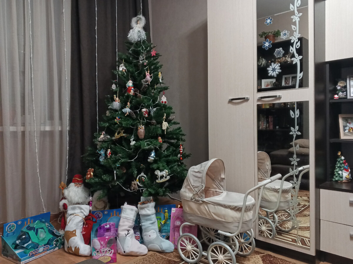 Вот так выглядела елочка вечером 30 декабря. А уже утром дети с восторгом открывали свои подарки. Пупс Лизы вместе с маленькими куколками спрятался в коляске. 