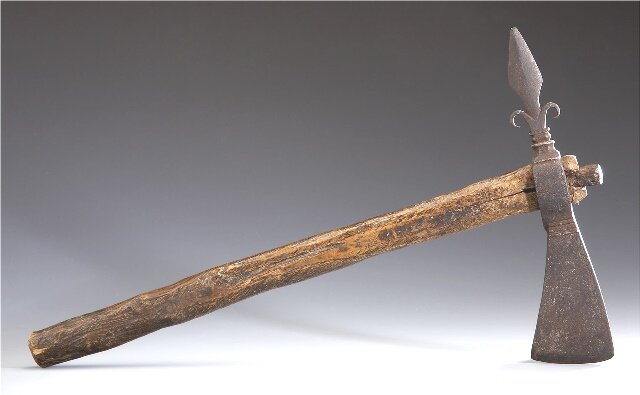 A GREAT LAKES TOMAHAWKc. 1820composed of a wood haft, of slightly expanding circular section, surmounted by a hand-wrought iron spontoon blade, with faint maker's markLength: 17 inches