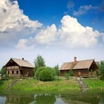    Summer from rural landscape. Wooden house near lake admin