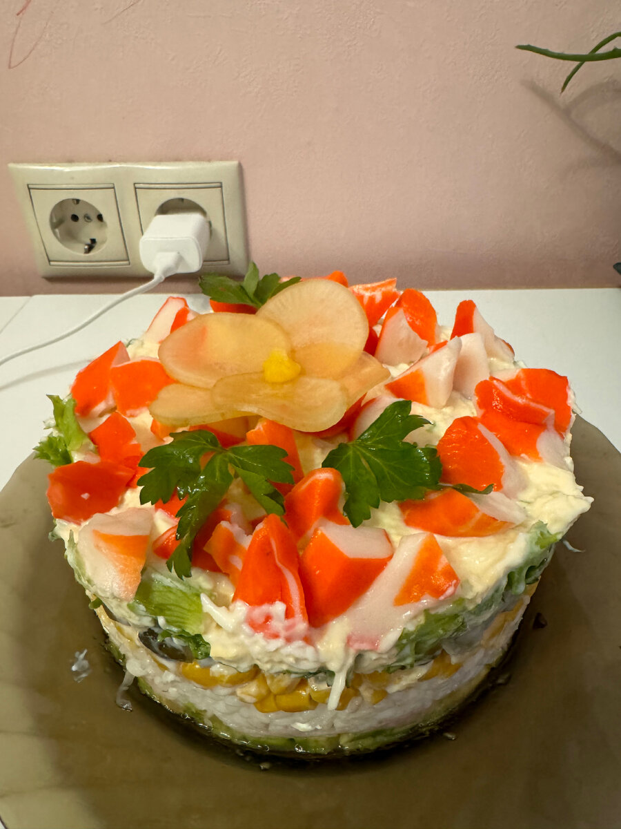 Мой крабовый салат, в составе рис . Цветочек сделала из дайкона и замочила в соевом соусе . Крабовые палочки порезала треугольником, для формы использовала кулинарное кольцо . Первые три слоя не промазывала соусом