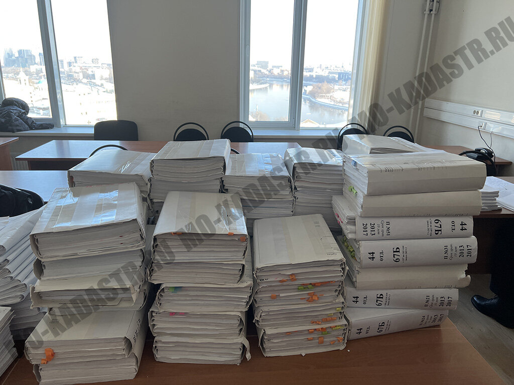 Целый стол томов дела 