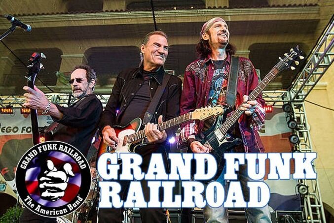 Группа Grand Funk Railroad образца 2001-2018 года. Слева - бас-гитарист Мел Швхер, справа - гитарист Брюс Кулик, в центре - вокалист Макс Карл, заменивший ушедшего в 1998 году Марка Фарнера