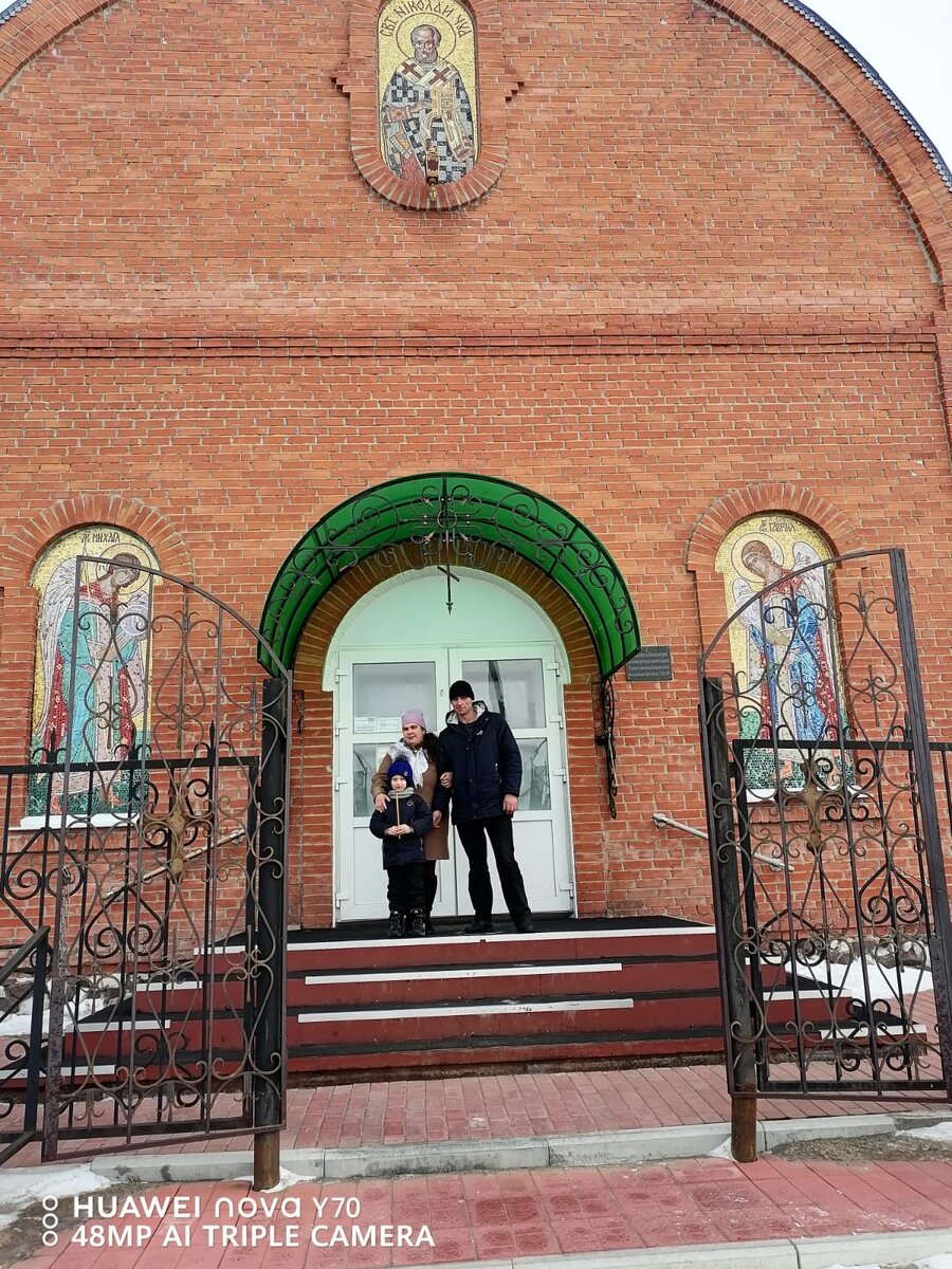С крестником на пороге церкви.
