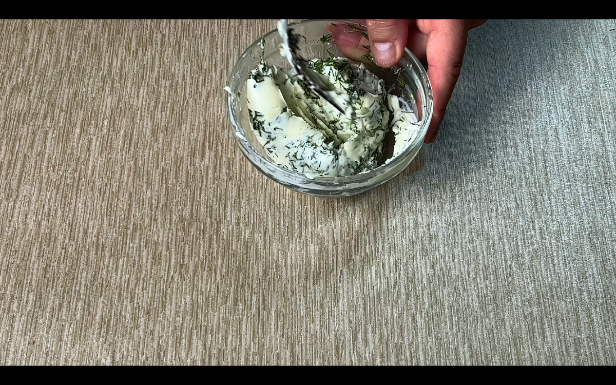 Теперь берем 100г сливочного масла, добавляем в к нему 40г мелко напезанного укропа, хорошо перемешиваем и намазываем на отбивные. Заворачиваем наши рулетики из свинины,как показано на фото.