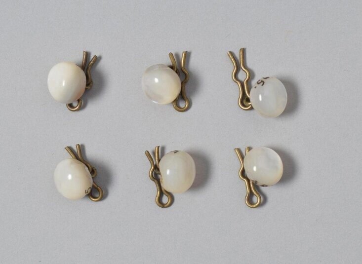 Button1875 (made) https://collections.vam.ac.uk/item/O256939/button/ - Button for a waistcoat, with fastener; Shell, 1875