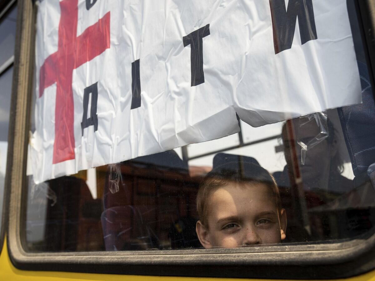    Мальчик в автобусе во время эвакуации в районе Лимана© AP Photo / Evgeniy Maloletka