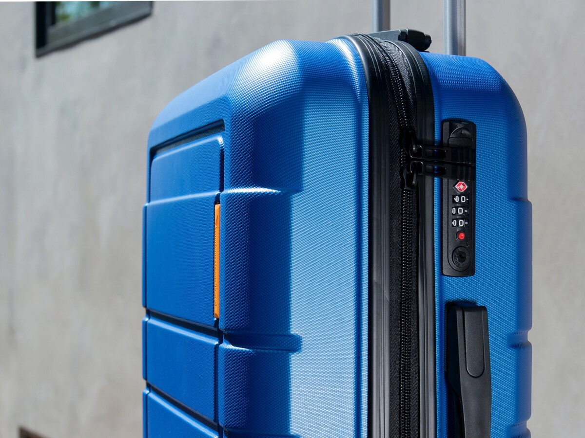 The TSA lock on the suitcase is marked with a special symbol in the form of a red diamond. Source: Unsplash