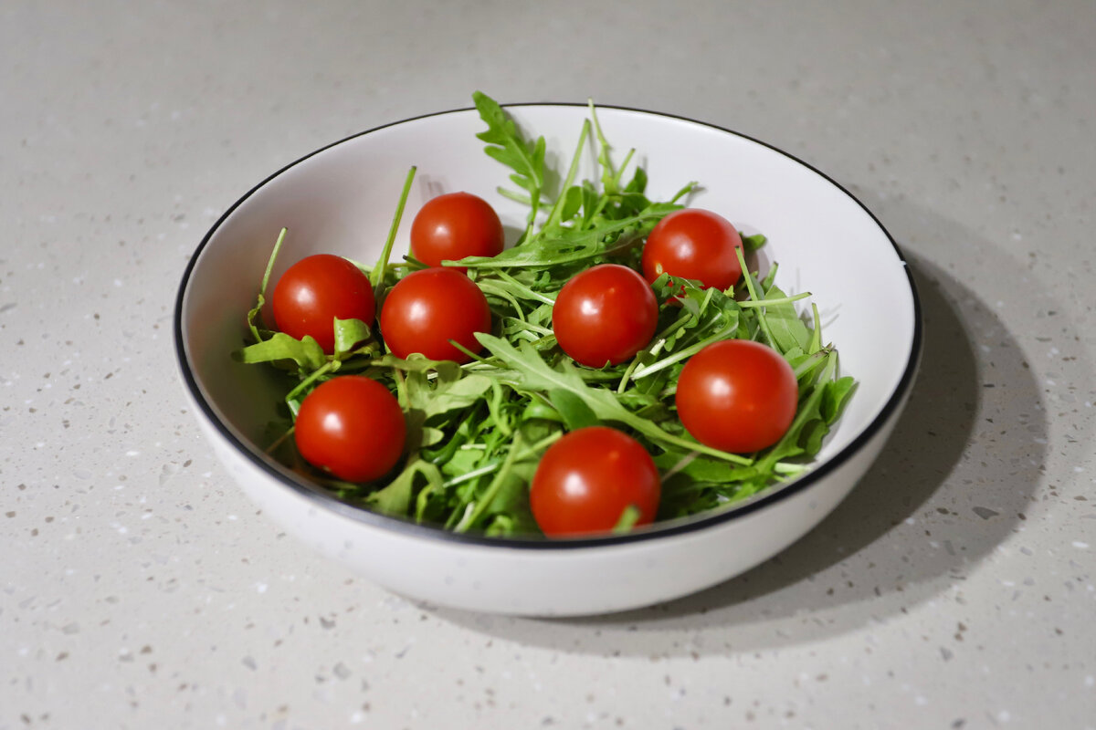 Помыть и смешать руколу с помидорами 