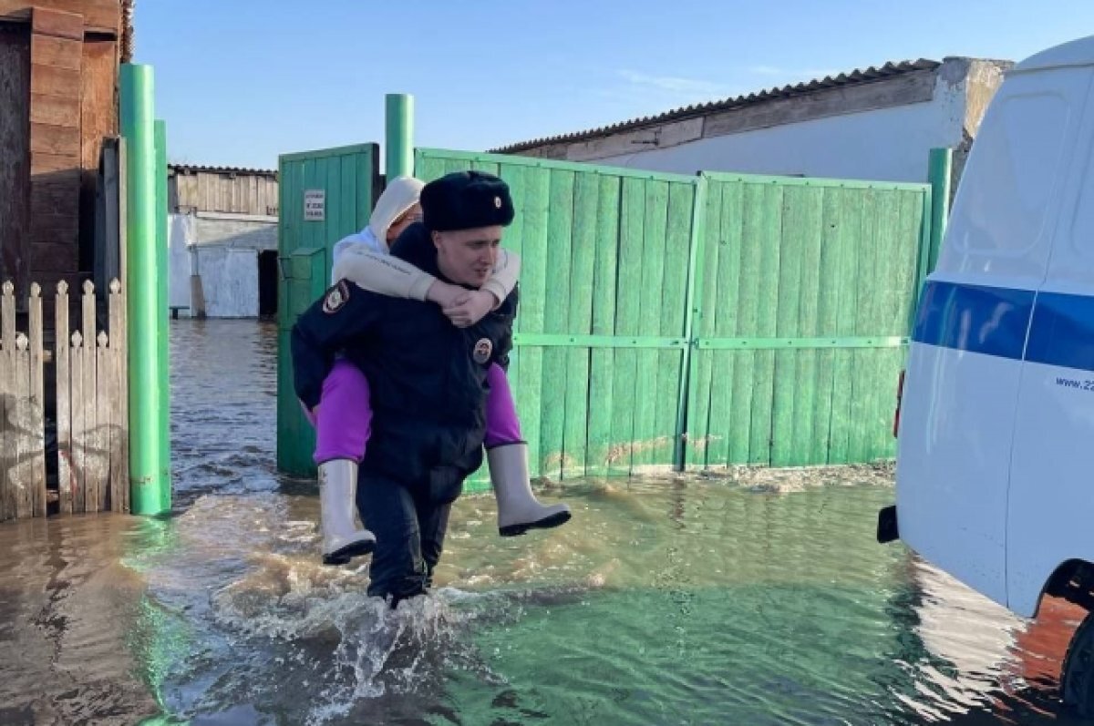    Полицейские эвакуируют жителей из подтопленных домов.
