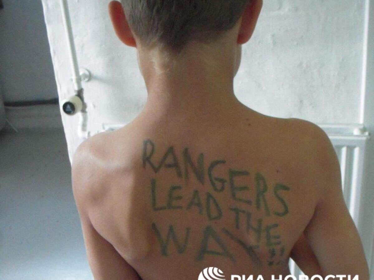    Фото ребенка с написанным на спине девизом американских рейнджеров, найденное в телефоне у неизвестного мертвого боевика в Попасной© РИА Новости